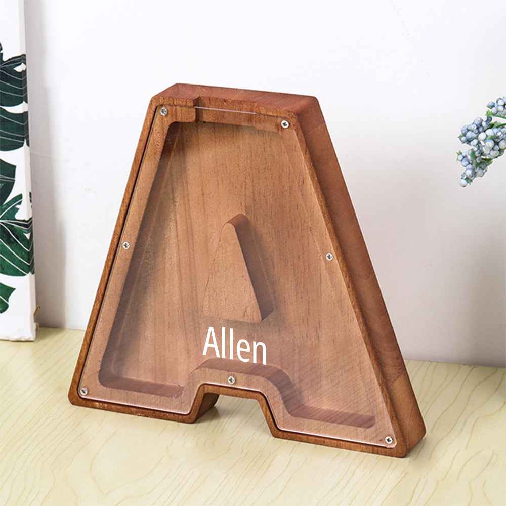 MadeMine personalised wooden piggy bank in letter A shape with clear front walnut finish and name Allen