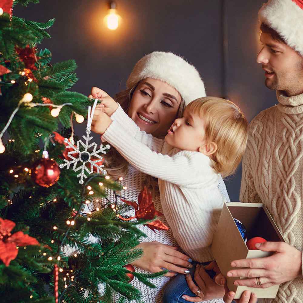 Family decorating Christmas tree with personalized photo snowflake ornament from MadeMine
