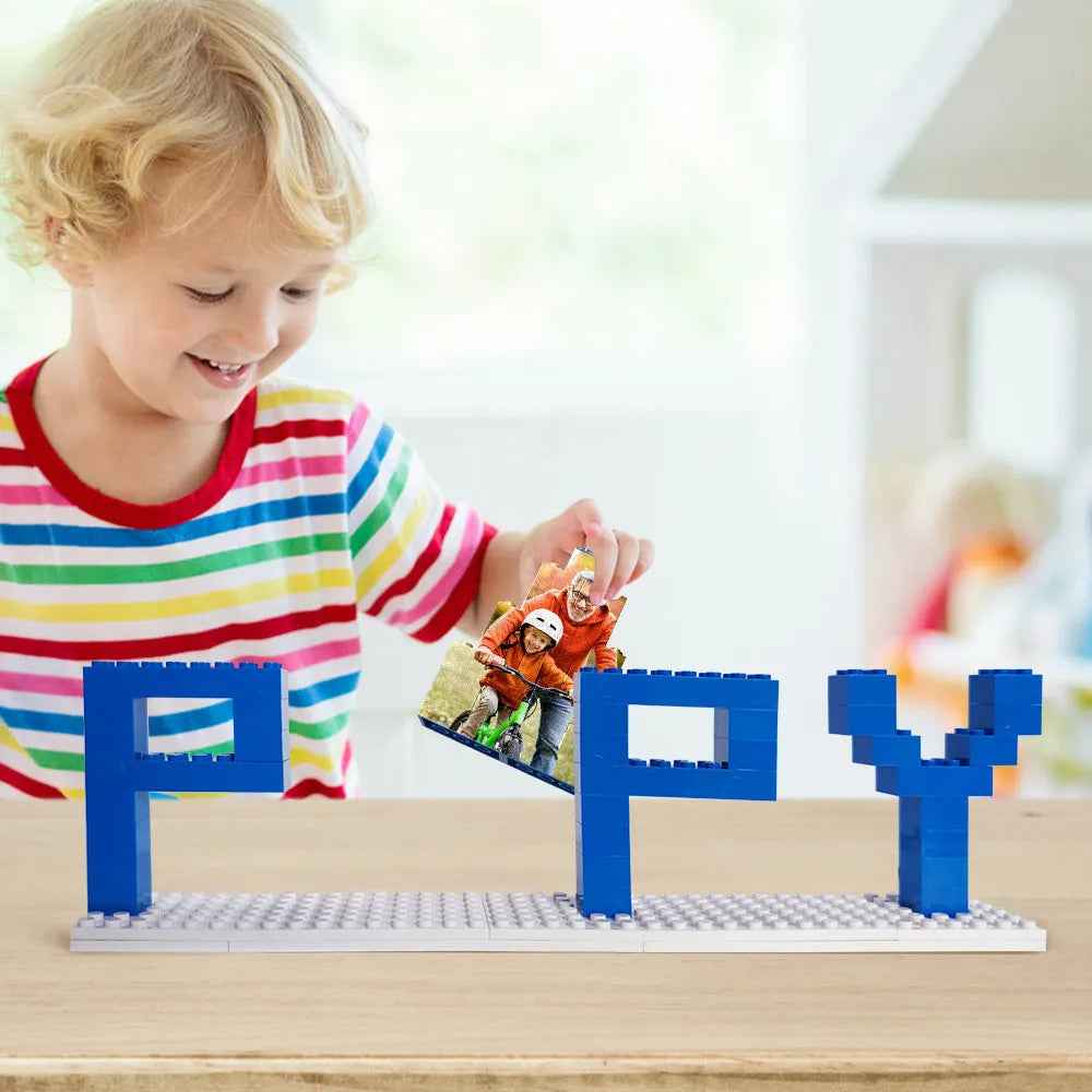 Child placing a puzzle piece in a personalized dad photo puzzle with colorful letters spelling happy