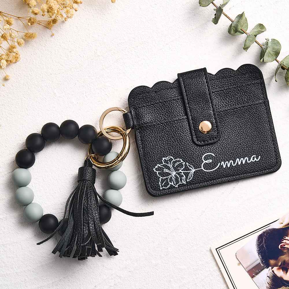 MadeMine personalized birth flower wallet in black with floral design and matching tassel keychain bracelet