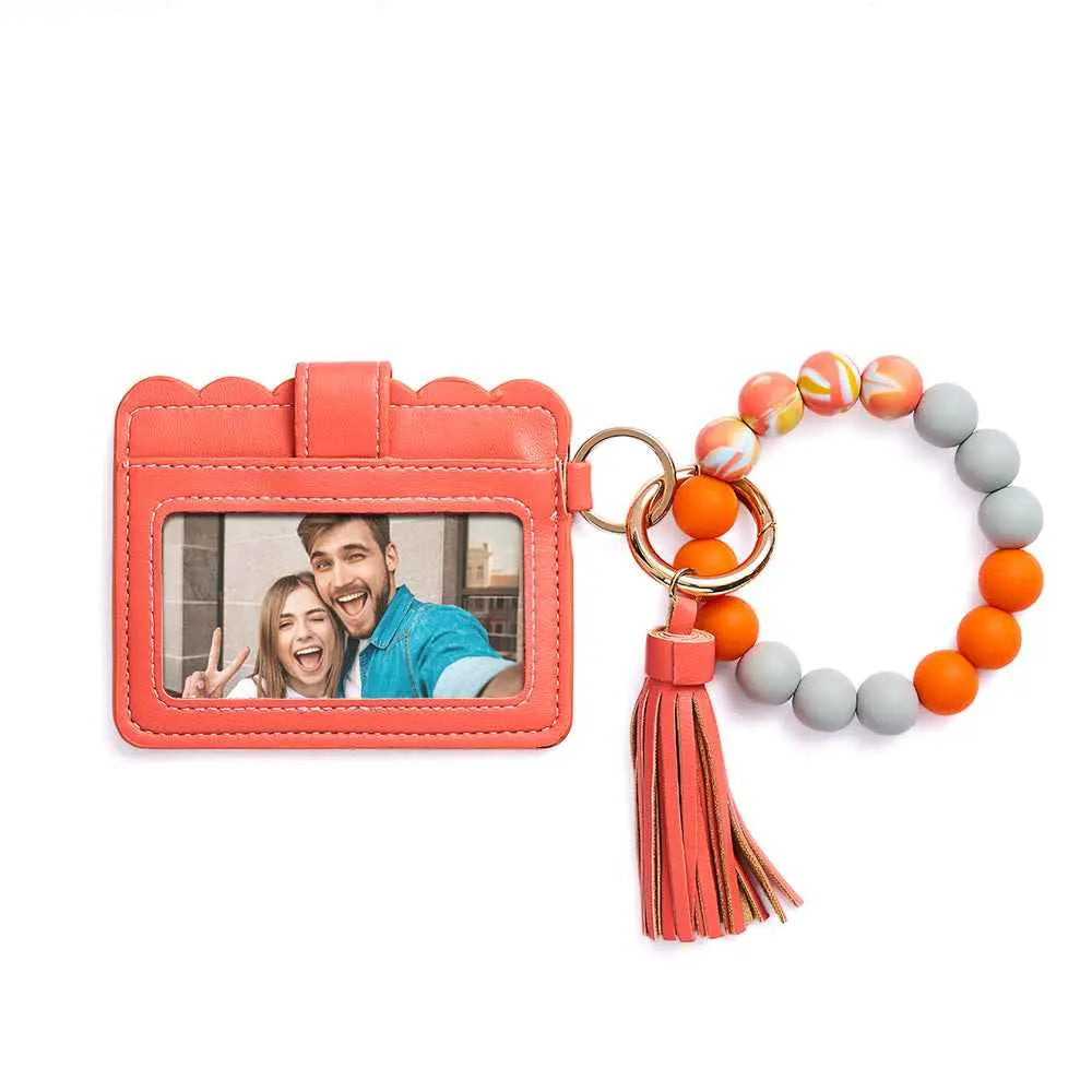 MadeMine personalized birth flower wallet in coral with clear ID window and beaded tassel keychain