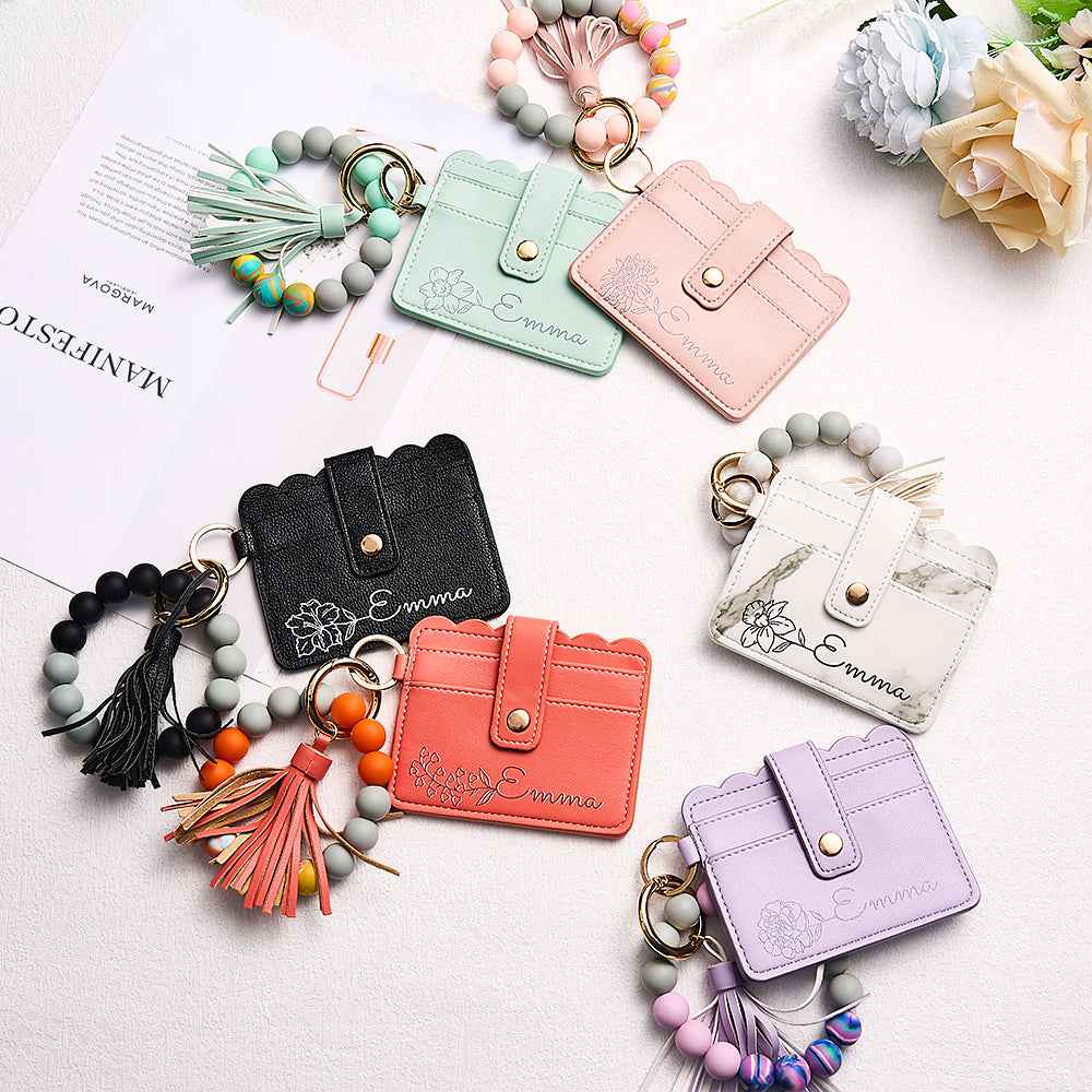 MadeMine personalized birth flower wallet collection in pastel and neutral colors with beaded keychains and tassels