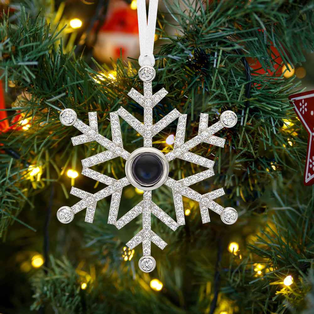 MadeMine personalized photo snowflake ornament in silver with a central photo frame hanging on a Christmas tree