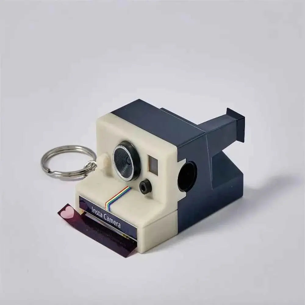 MadeMine custom camera keychain shaped like a vintage instant camera with detailed lens and photo slot