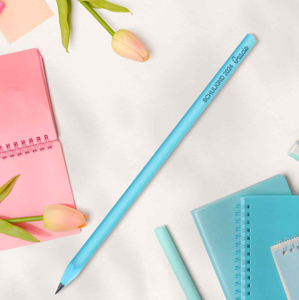 MadeMine blue personalised pencils for school showing single customised pencil with notebooks and tulips