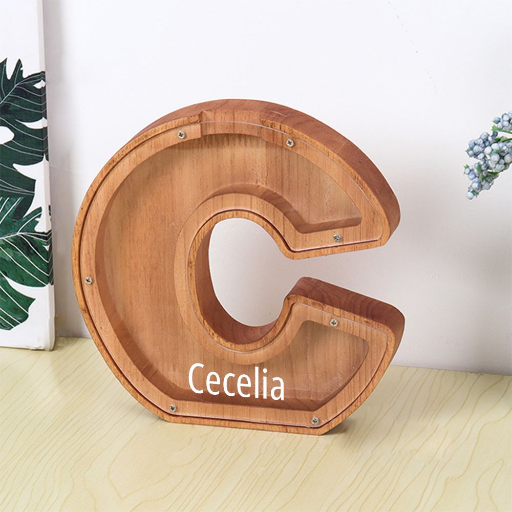MadeMine personalised wooden piggy bank shaped letter C with clear front and personalised name Cecelia