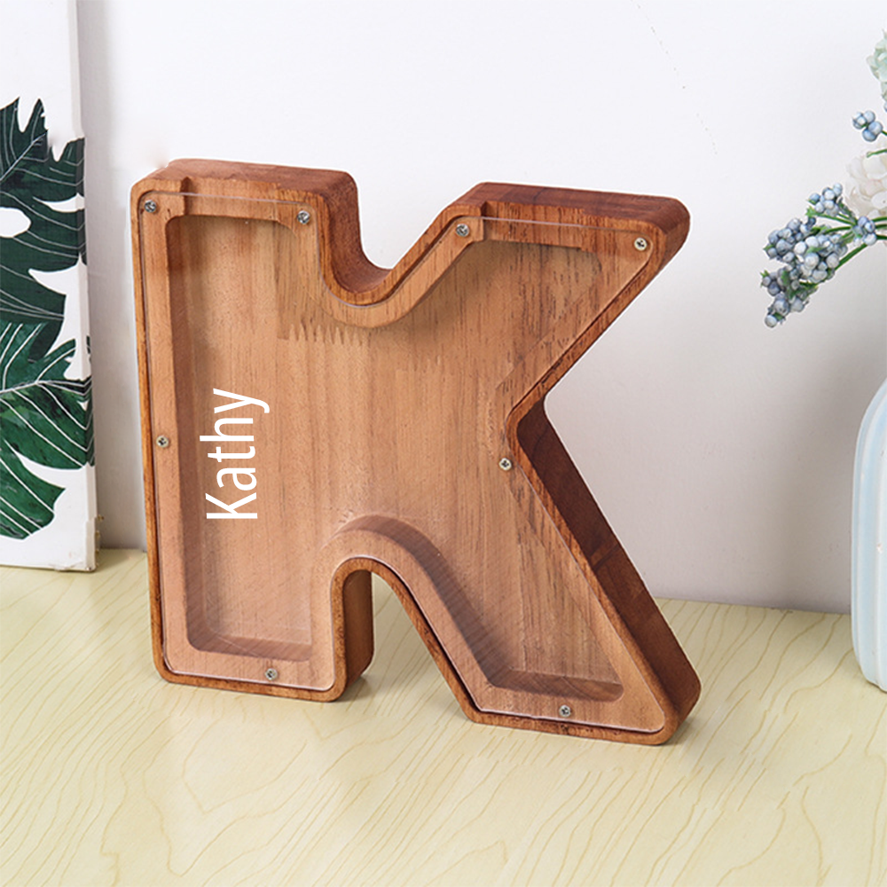 personalised wooden piggy bank letter K with clear acrylic front displaying name Kathy on wood