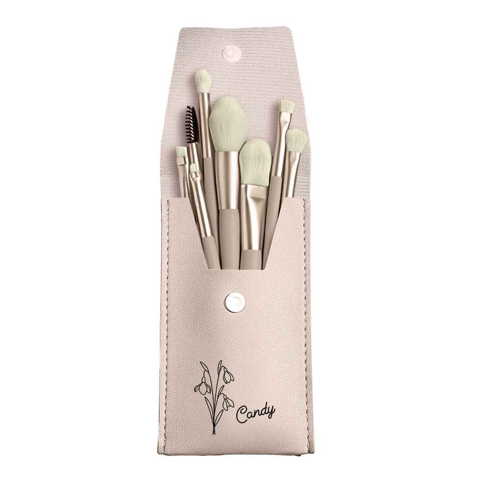 Personalized makeup brush set with bag featuring light beige brushes in a matching pouch with floral design and name