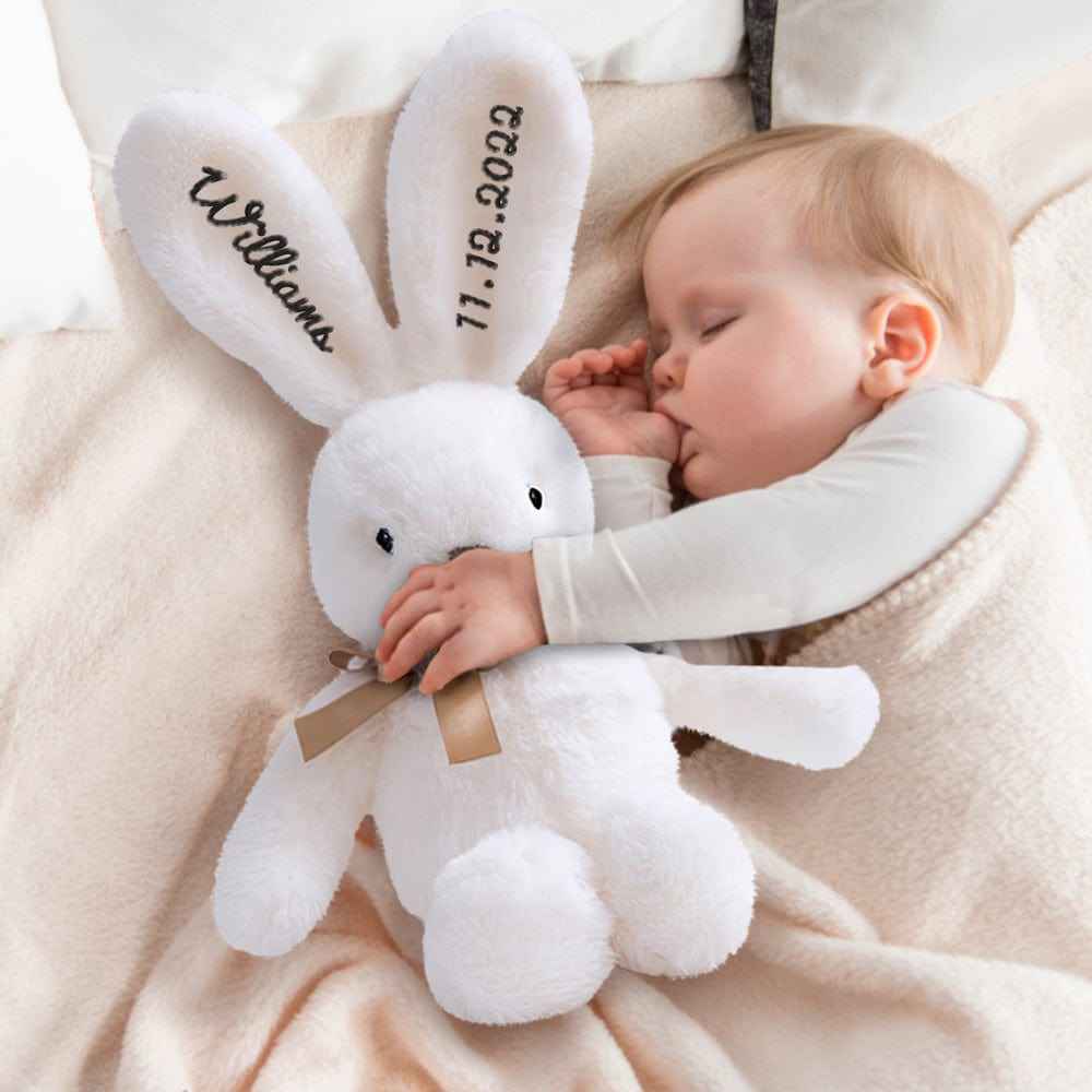 MadeMine personalised bunny rabbit toy white plush with embroidered name and date baby cuddling asleep