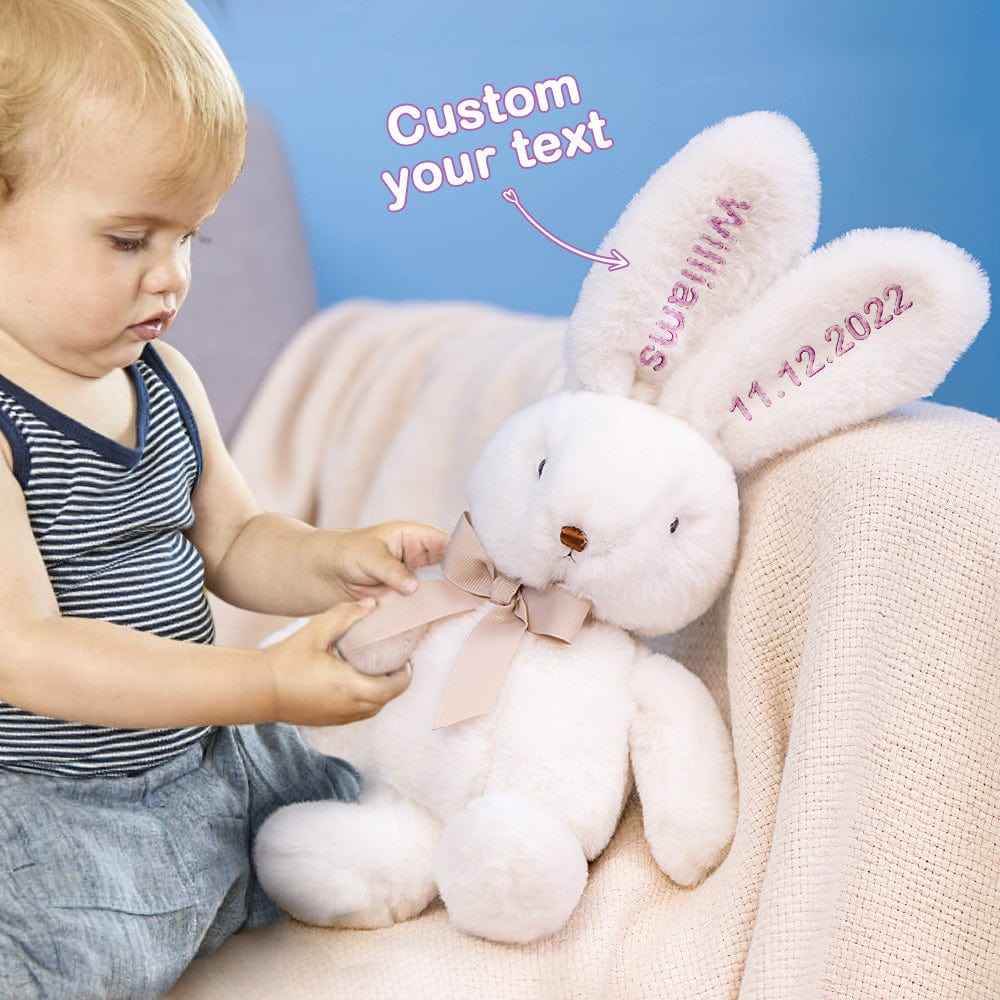 MadeMine personalised bunny rabbit toy white plush with embroidered ears and ribbon bow held by toddler