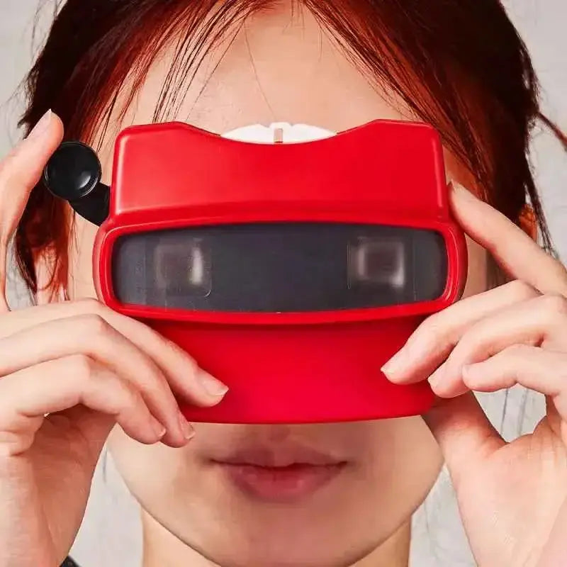 Red personalized photo viewer with reel held up to eyes by person showing front view