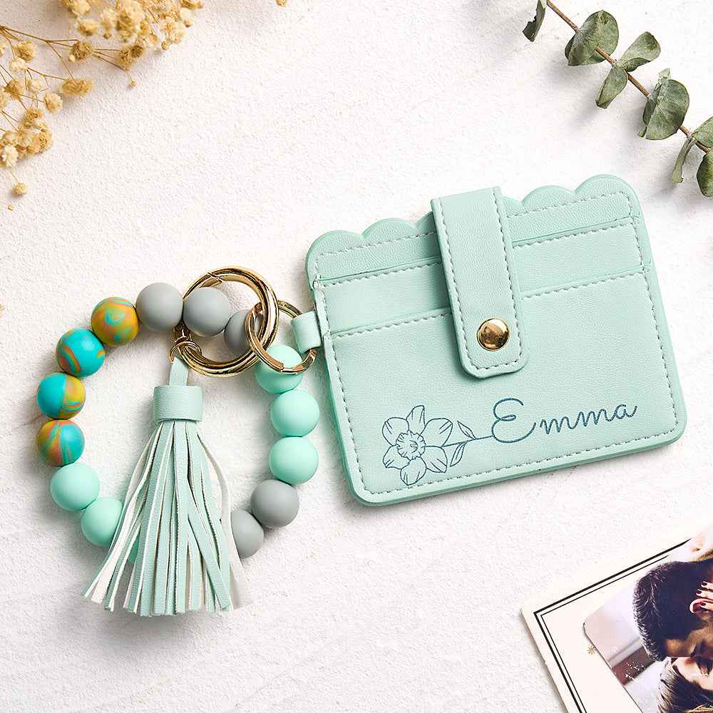 MadeMine personalized birth flower wallet in mint green with name Emma and beaded tassel keychain