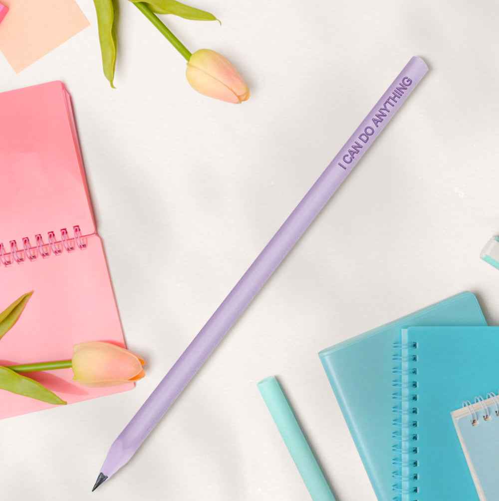 MadeMine pastel purple pencil with I CAN DO ANYTHING text among notebooks and tulips personalised pencils for school